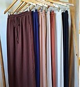 Cotton pants and palazzos hanging in many shades