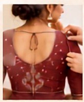 A blouse being fitted and pinned at the back