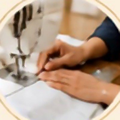 Hands guiding fabric through a sewing machine